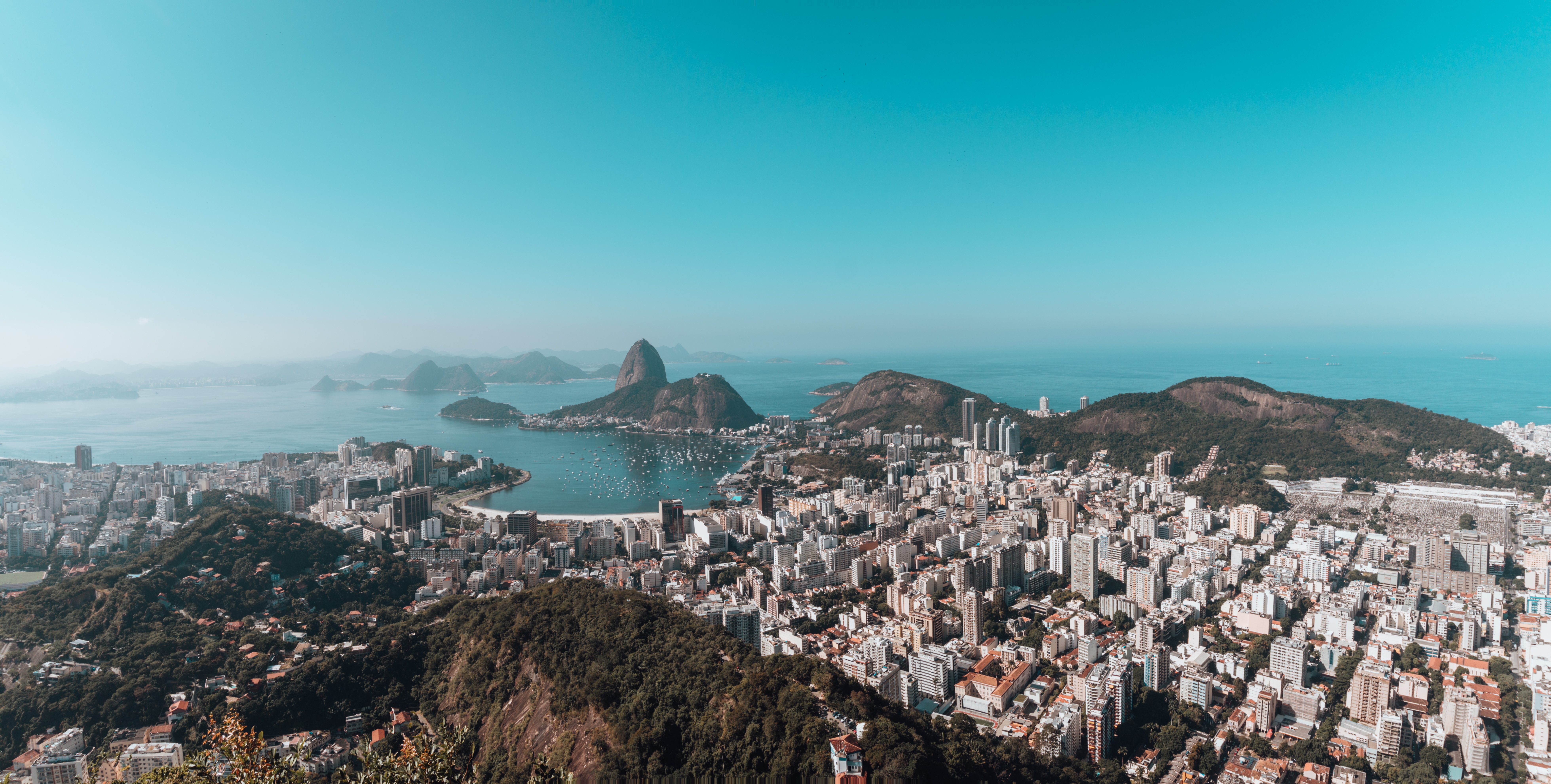 Landscape of rio de janeiro surrounded by the sea under a blue sky in brazil